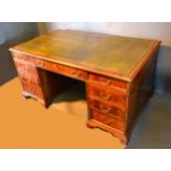 A Mahogany Twin Pedestal Desk, the green tooled leather inset top above nine drawers with brass
