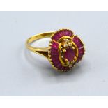 An 18ct Gold Ruby And Diamond Ring set with a central oval ruby flanked by six diamonds and within
