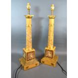 A Pair Of Tole Ware Style Table Lamps with chinoiserie decoration upon a mustard ground