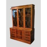 A 20th Century Library Bookcase, the moulded cornice above three astragal glazed doors, the lower