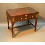 A French Writing Desk with a pullout writing surface above a drawer with brass handles raised upon