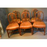 A Set of Six Mahogany Dining Chairs each with an oval pierced wheatsheaf back above a stuffover seat