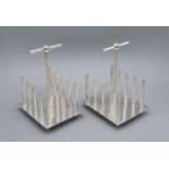 A Pair Of Silver Plated Four Division Toast Racks In The Style Of Christopher Dresser 12 cms long