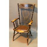 A Late 19th Century American Stick Back Armchair with a shaped seat raised upon turned legs with