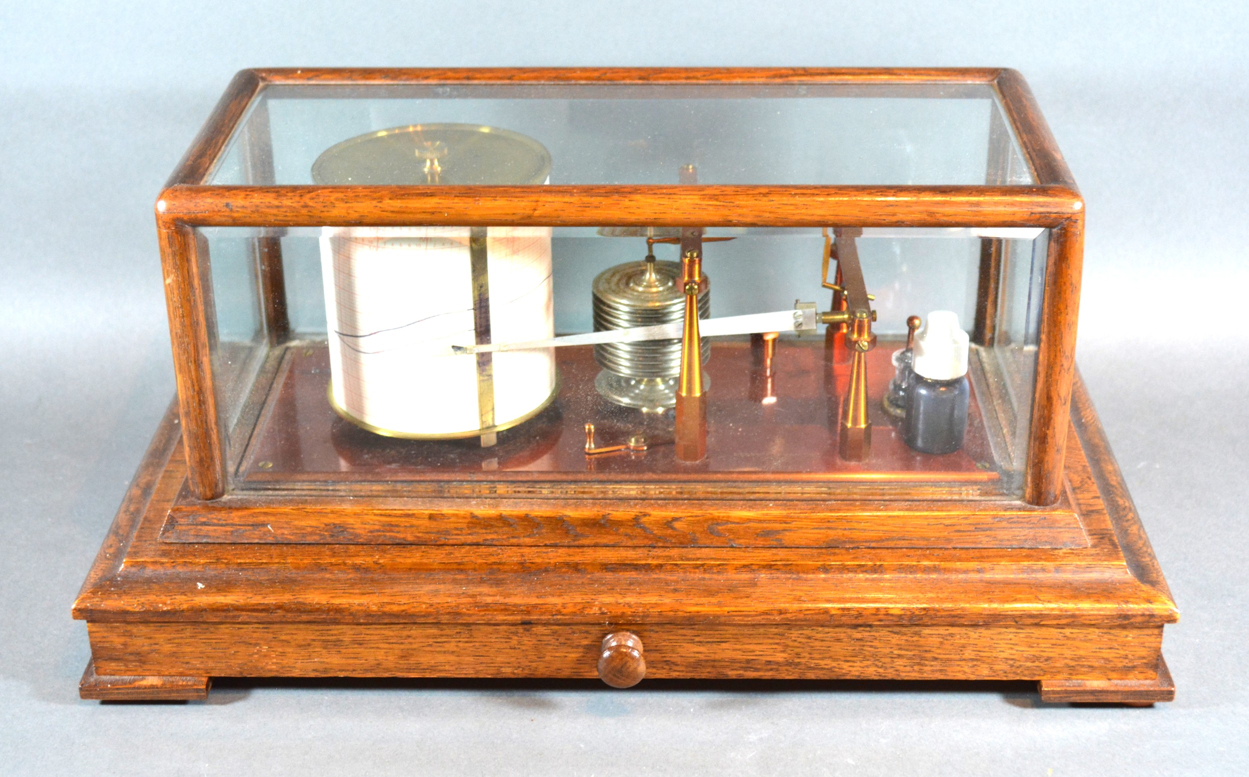 A Barograph By Negretti & Zambra within glazed case complete with chart drawer, 42 cms long