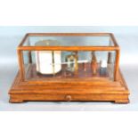 A Barograph By Negretti & Zambra within glazed case complete with chart drawer, 42 cms long