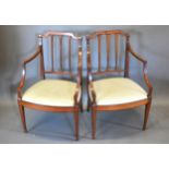A Pair Of 19th Century Mahogany Armchairs each with a drop in seat raised upon square tapering legs