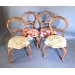 A Set Of Four Victorian Walnut Balloon Back Dining Room Chairs each with a carved pierced rail