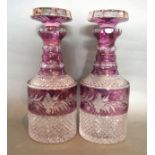 A Pair Of Cut Glass And Purple Overlay Decanters With Stoppers, 28 cms tall