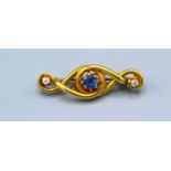A Yellow Metal Brooch set with central sapphire flanked by diamonds 5.3 gms. 4 cms long