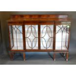 An Edwardian Mahogany Break Front Bookcase with a low galleried back above four astragal glazed