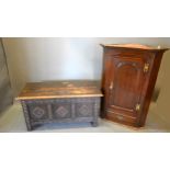 An Oak Coffer, the hinged top above a three panel front flanked by stiles, 107 cms wide x 45 cms
