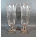 A Pair Of Cut Glass Flared Rim Storm Vases with square stepped bases 45 cms tall