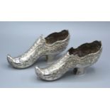 A Pair Of Dutch Models Of Shoes decorated in relief 19 cms long