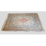 A North West Persian Woollen Rug with a central medallion within an all over design upon a cream and