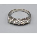 An 18ct White Gold Five Stone Diamond Ring with five graduated diamonds claw set, 4.3 gms. ring size