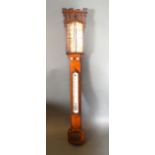 A 19th Century Oak Stick Barometer of castellated form, the dial inscribed Adams, Lombard Street,