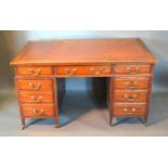 An Edwardian Mahogany Twin Pedestal Desk with an arrangement of nine drawers with brass handles