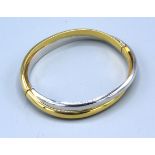 An 18ct. White And Yellow Gold Crossover Bangle 20.1 gms. 5 x 6 cms