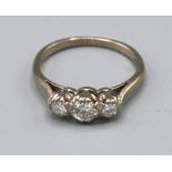 An 18ct White Gold Three Stone Diamond Ring set with three graduated diamonds within a pierced