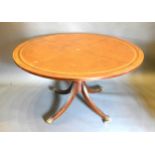 A 20th Century Mahogany Circular Centre Table with tooled leather inset top above a turned centre