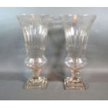 A Pair Of Cut Glass Flared Rim Storm Vases with square stepped bases 40 cms tall