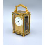 A 19th Century French Champleve Carriage Clock of serpentine form, the enamel circular dial with