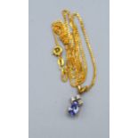 A 9ct. Gold Pendant set oval tanzanite with three diamonds above together with a 9ct. gold chain 3