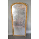 A 19th Century French Gilded Over Mantle Mirror of arched form, 157 x 70 cms