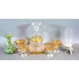 A Cut Glass Decanter with four matching small glasses all engraved decorated upon a yellow ground