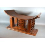 An Ashanti Carved Stool Of Shaped Form 56 cms long x 28 cms deep x 32 cms high