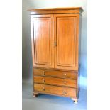 An Edwardian Mahogany Press Cupboard, the moulded cornice above two panelled doors above three