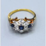 A 9ct. Yellow Gold Diamond And Sapphire Cluster Ring set with six central sapphires surrounded by