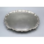 A Chester Silver Salver Of Shaped Outline with four scroll feet 27 ozs. 31 cms diameter