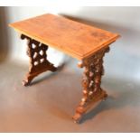 A Victorian Burr Walnut Centre Table, the rectangular moulded top above twin end carved and