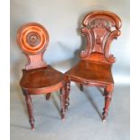 A Regency Mahogany Hall Chair with a circular moulded back above a panel seat raised upon ring