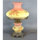 A Gilt Metal And Opaque Glass Oil Lamp with opaque glass shade decorated with roses converted to
