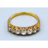 An 18ct. Gold Seven Stone Diamond Ring, the seven graduated stones claw set, 2.9 gms. ring size O