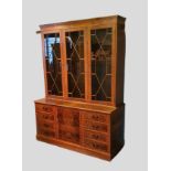 A 20th Century Library Bookcase, the moulded cornice above three astragal glazed doors, the lower