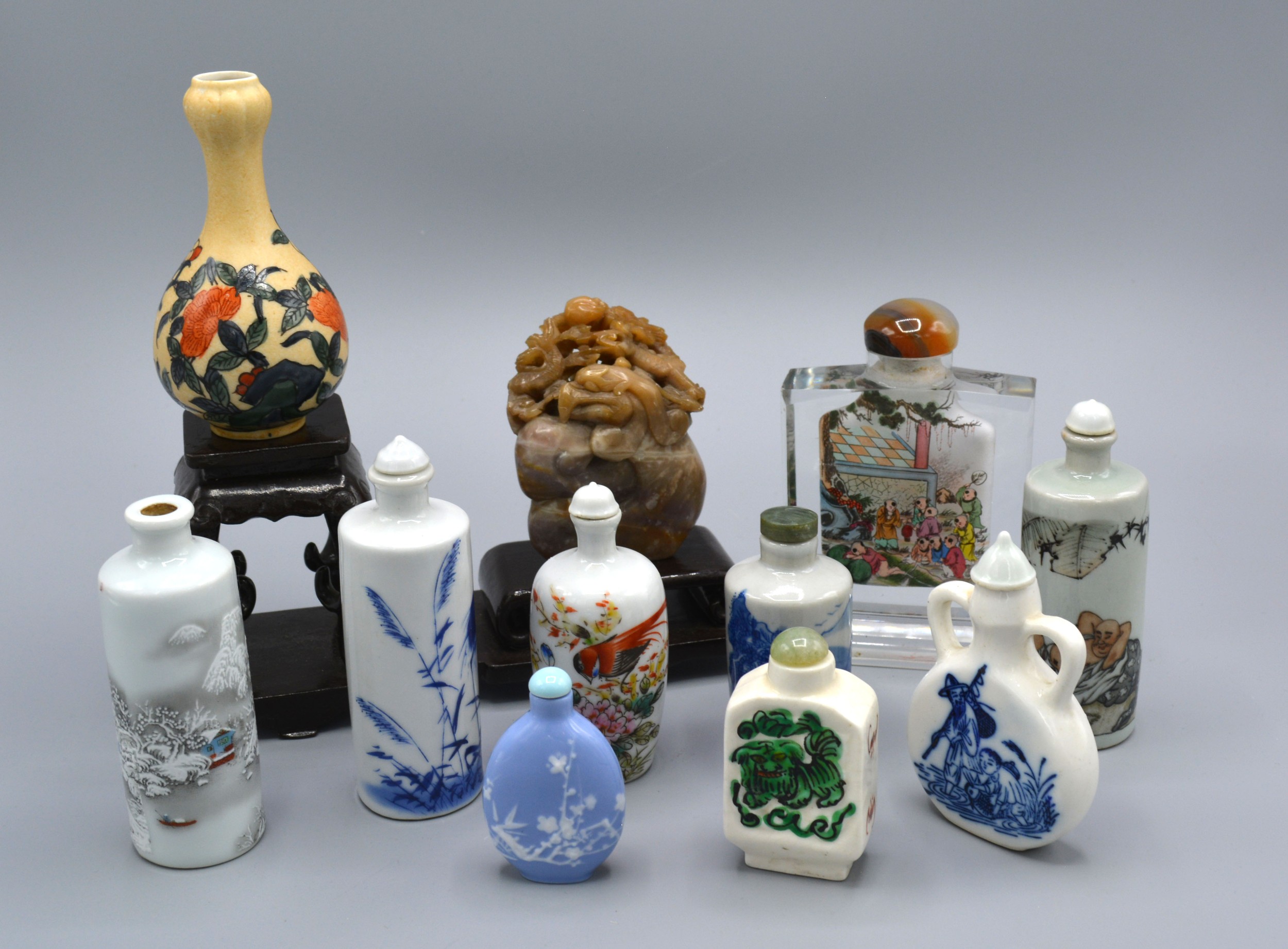 A Chinese Glass Scent Bottle reverse painted with figures and with agate stopper together with