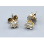 A Pair Of White Metal Diamond Set Ear Studs claw set approximately 0.25 ct. each