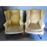 A Pair of Wingback Armchairs with cabriole legs and scroll feet