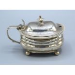 A George III Silver Mustard with shaped handle upon low bun feet, London 1814, 4 ozs.