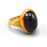 An 18ct. Gold Ring Set Oval Cabochon Garnet 7.1 gms, ring size M