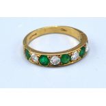 A 9ct. Yellow Gold Diamond And Emerald Set Ring set with five emeralds and four diamonds, 2.2 gms.