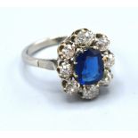 An 18ct. White Gold Diamond and Blue Stone Cluster Ring with a central blue stone surrounded by