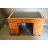 A Victorian Burr Walnut Twin-Pedestal Desk, the moulded top above nine drawers with knob handles,