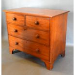 A Victorian Mahogany Straight Front Chest of two short and two long drawers with knob handles raised