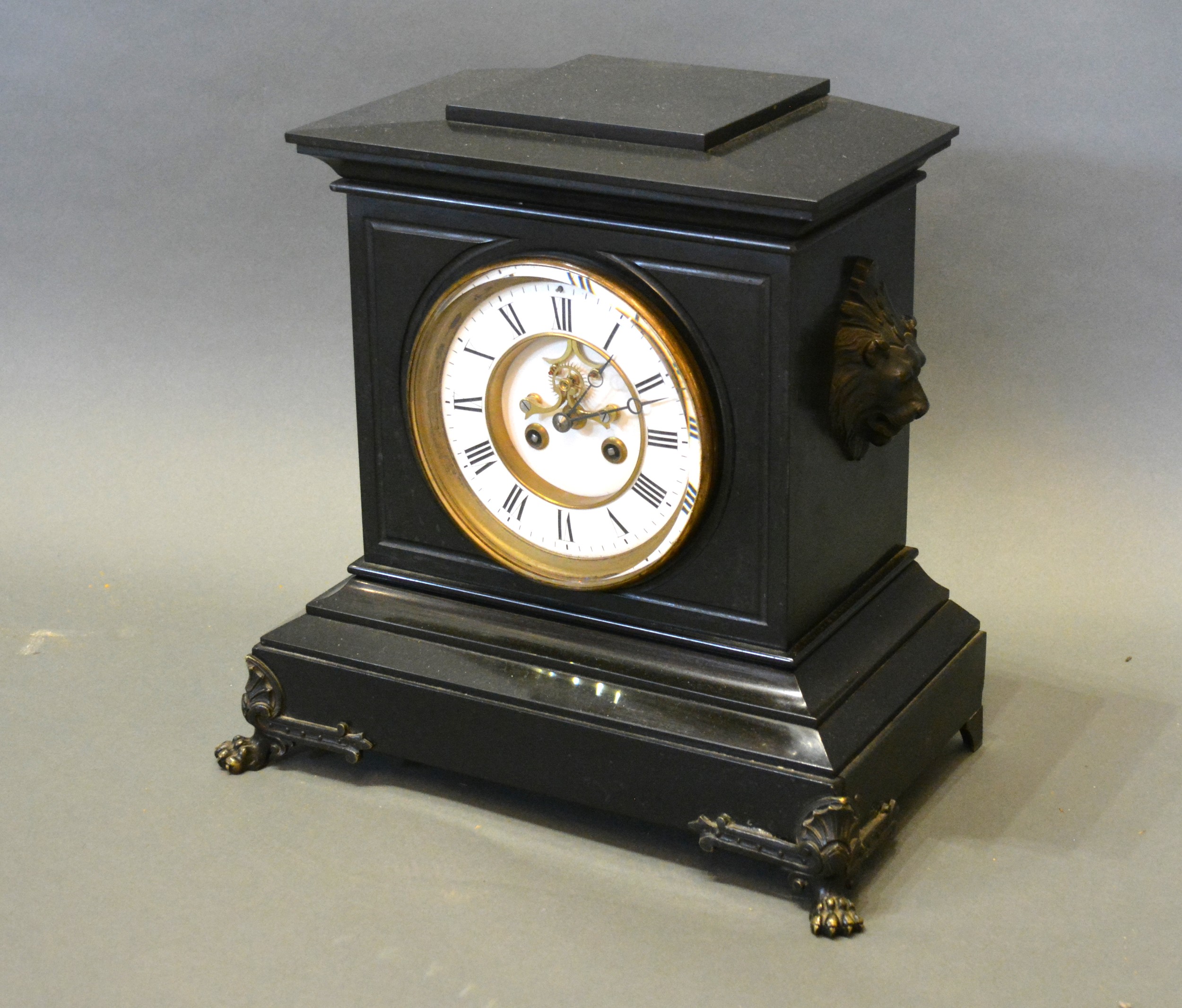 A Victorian Black Slate Mantle Clock, the enamel dial with Roman numerals and visible escapement