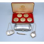 Two Silver Decanter Labels, a silver propelling pick, a silver plated cigarette case and a set of